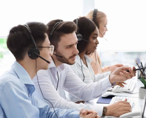 Call center professionals looking at computers.