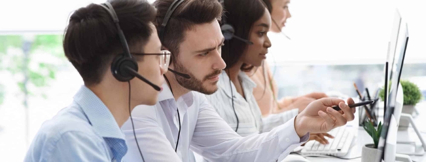 Call center professionals looking at computers.