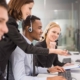 Image of a group of people assisting somebody in a call center.