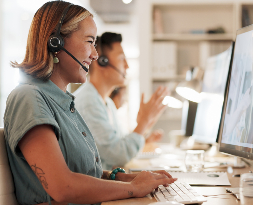 Side view of customer service representative smiling at her computer