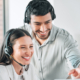 Collaboration, woman and man with headset in call center for client help